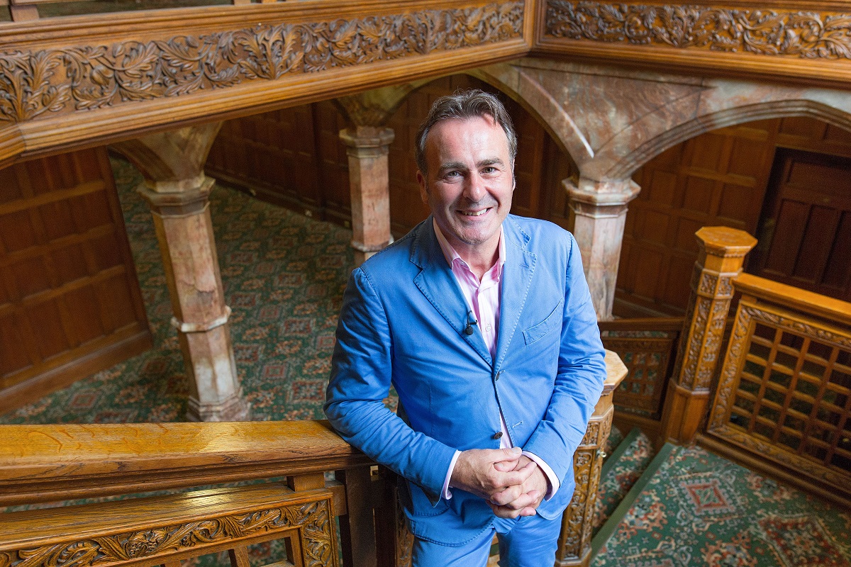 Paul Martin, presenter of Flog It, standing on a staircase at Bletchley Park